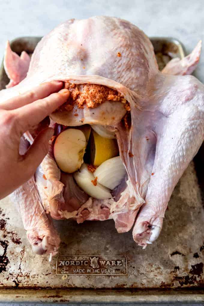 An image of a Thanksgiving turkey being prepared with a bacon rub.