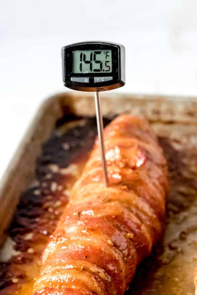 An image of a meat thermometer in a pork tenderloin at 145 degrees F.