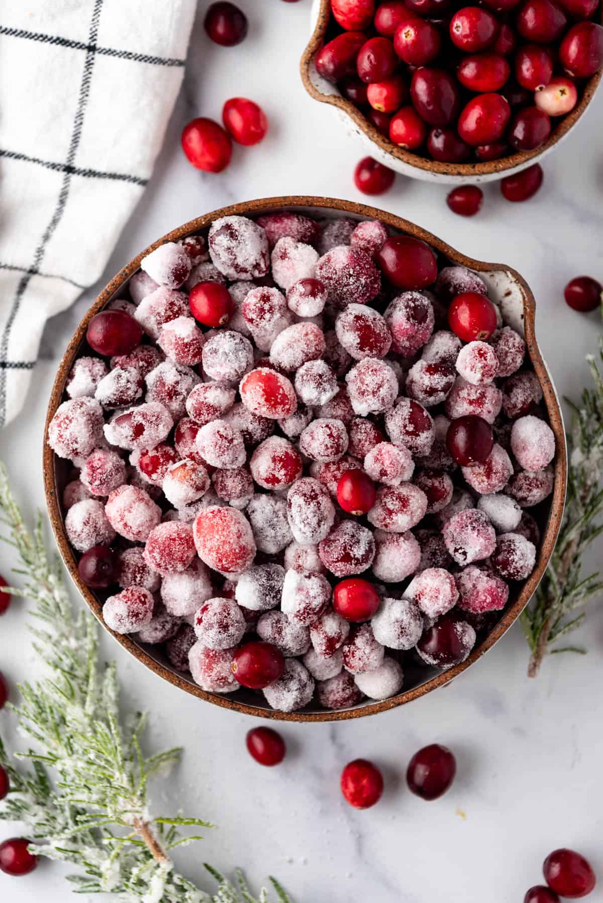 An overhead image of a bowl of sugared cranberries.