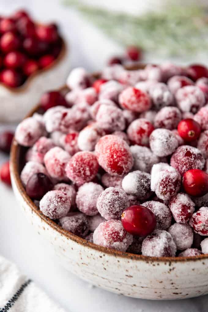 A close image of sugared cranberries in a bowl.