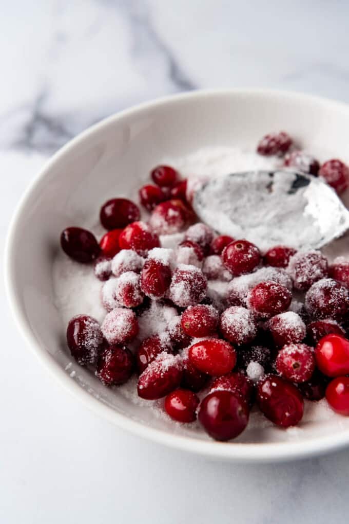 Tossing cranberries in sugar to make sugared cranberries.