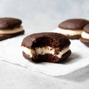 An image of a chocolate salted caramel whoopie pie with a bite taken out of it showcasing the soft texture.