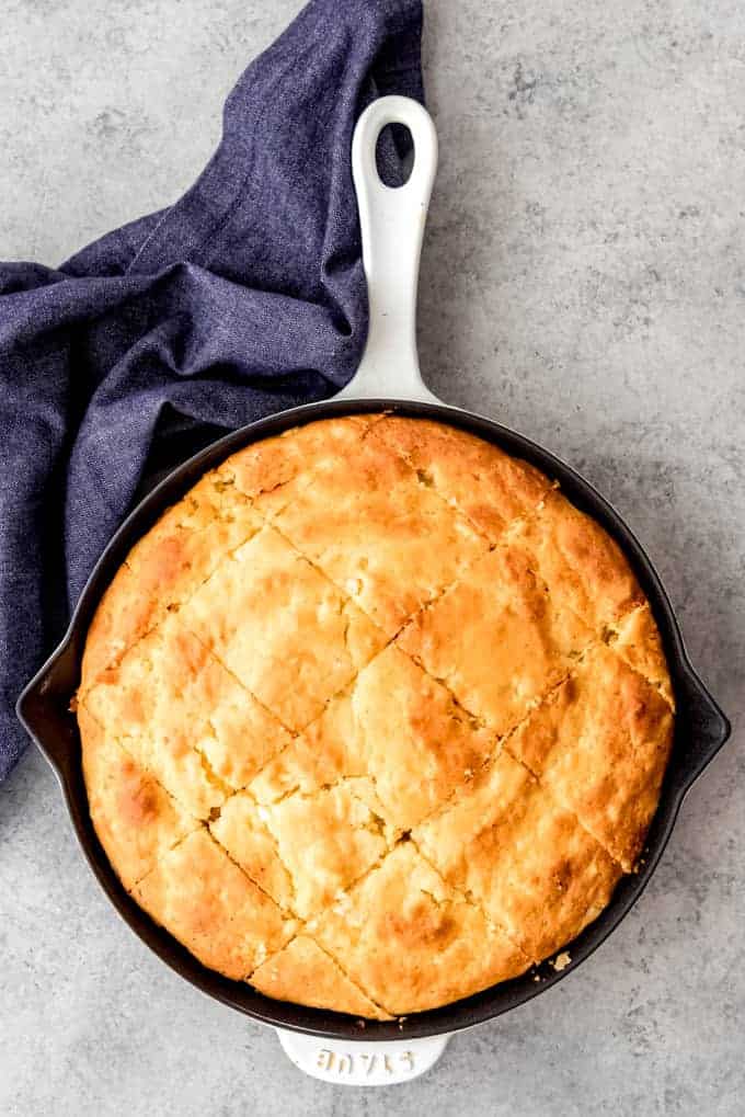 An image of homemade cornbread in a cast-iron skillet.