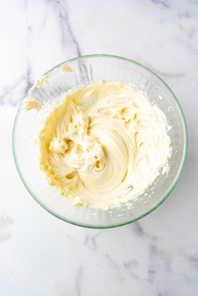 White chocolate cream cheese mixture in a mixing bowl.
