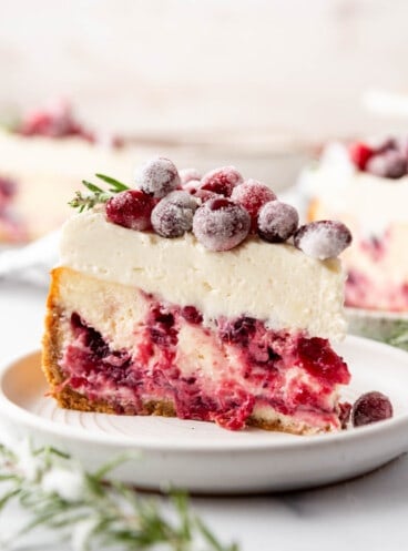 A slice of cranberry cheesecake on a plate.