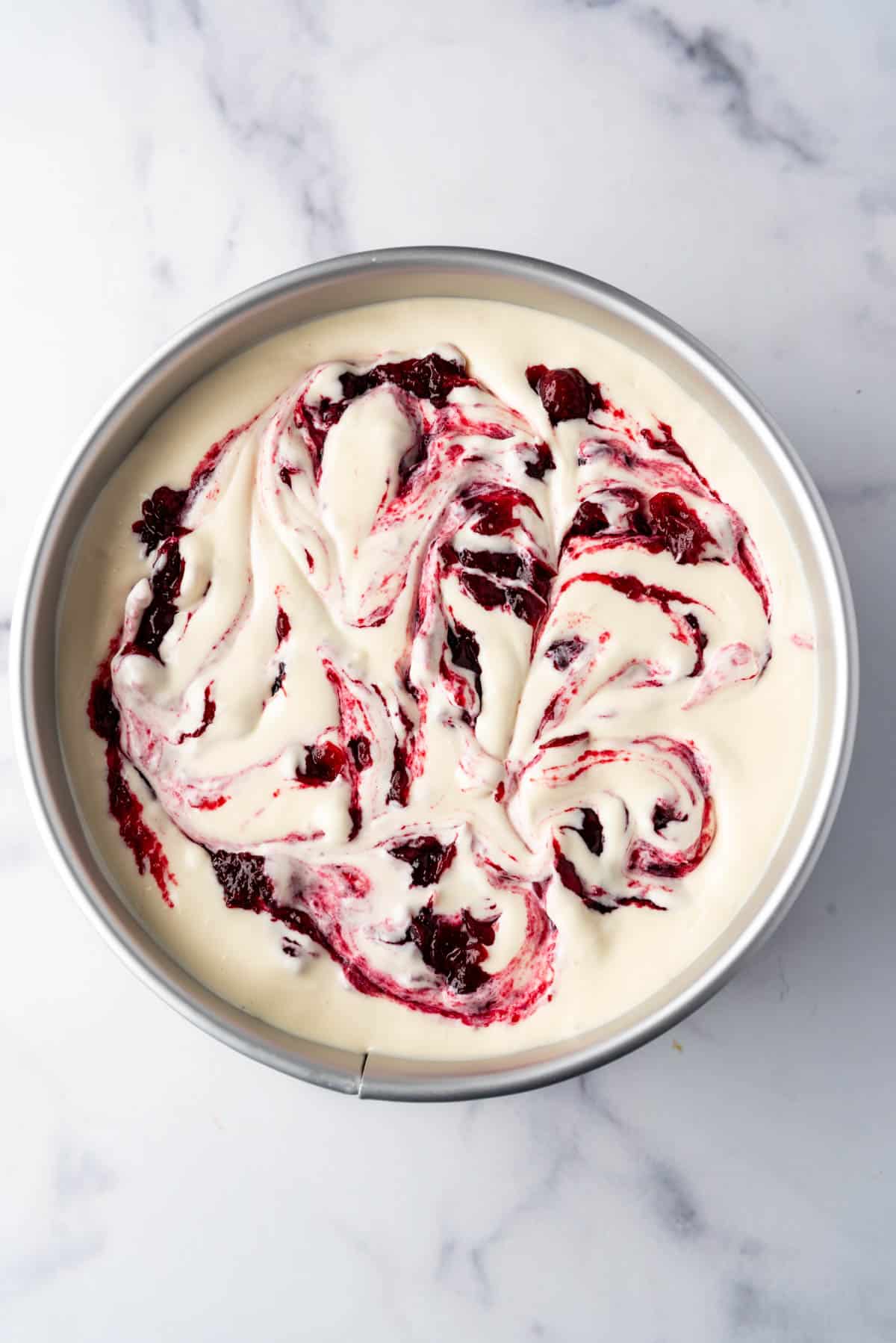 Cranberry sauce swirled into cheesecake.