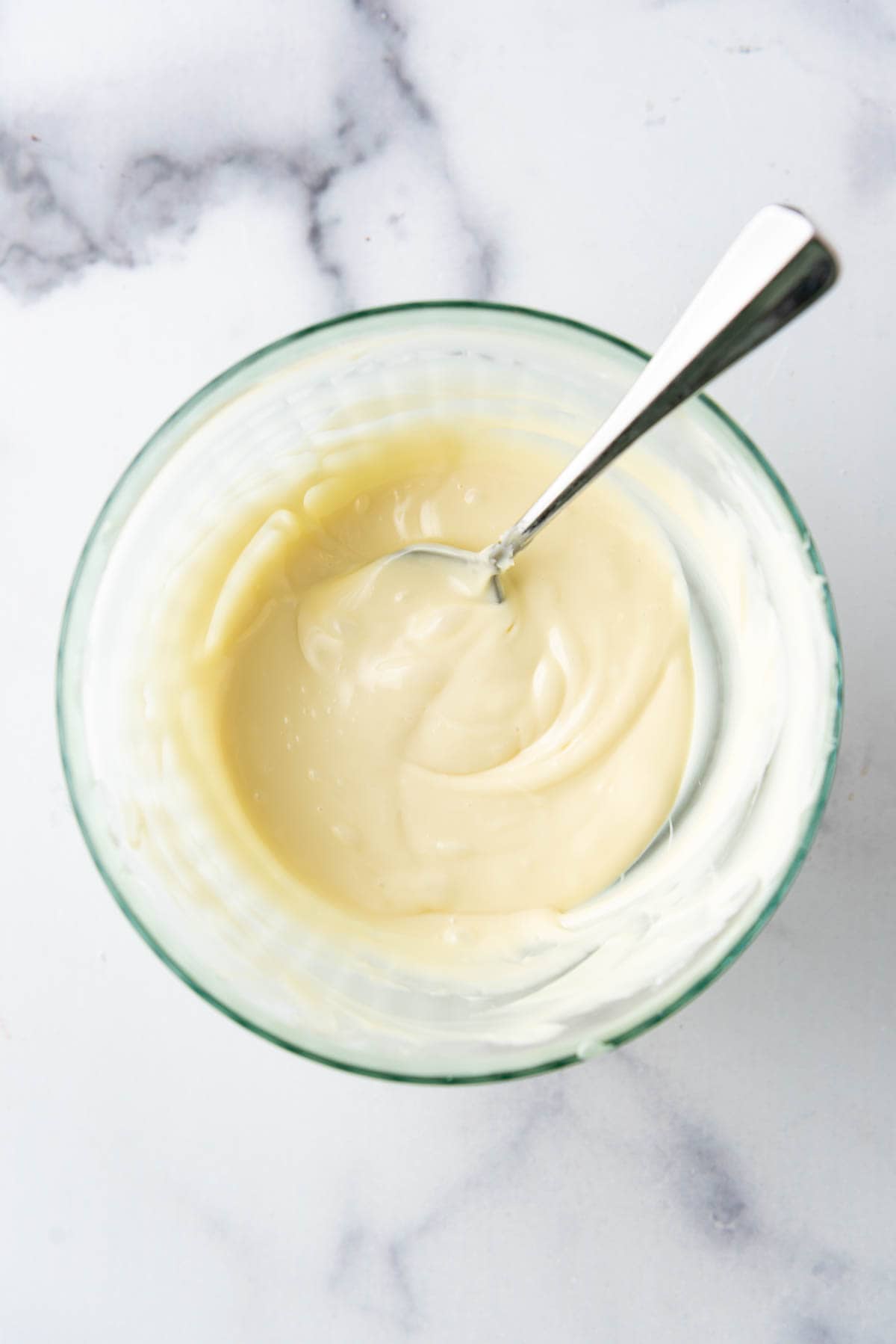 Melted white chocolate in a bowl.