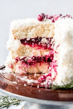 An image of a coconut cake filled with cranberry filling.