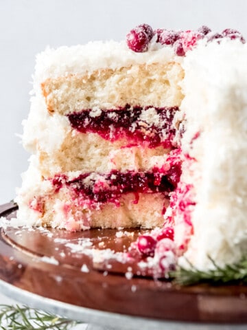 An image of a coconut cake filled with cranberry filling.