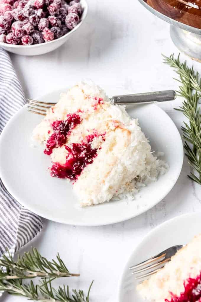 An image of a slice of cranberry coconut cake on a plate.