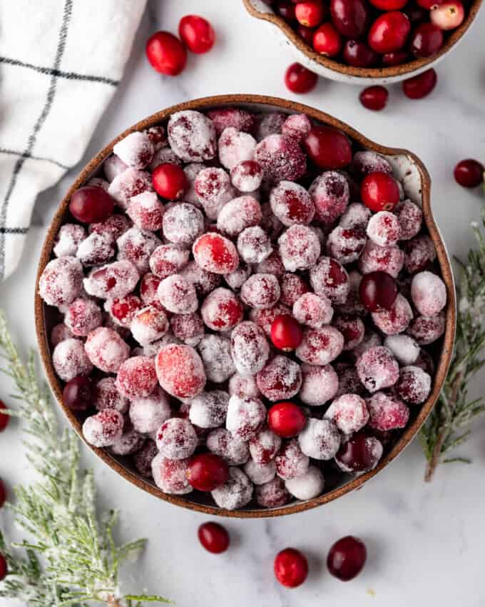 An overhead image of a bowl of sugared cranberries.