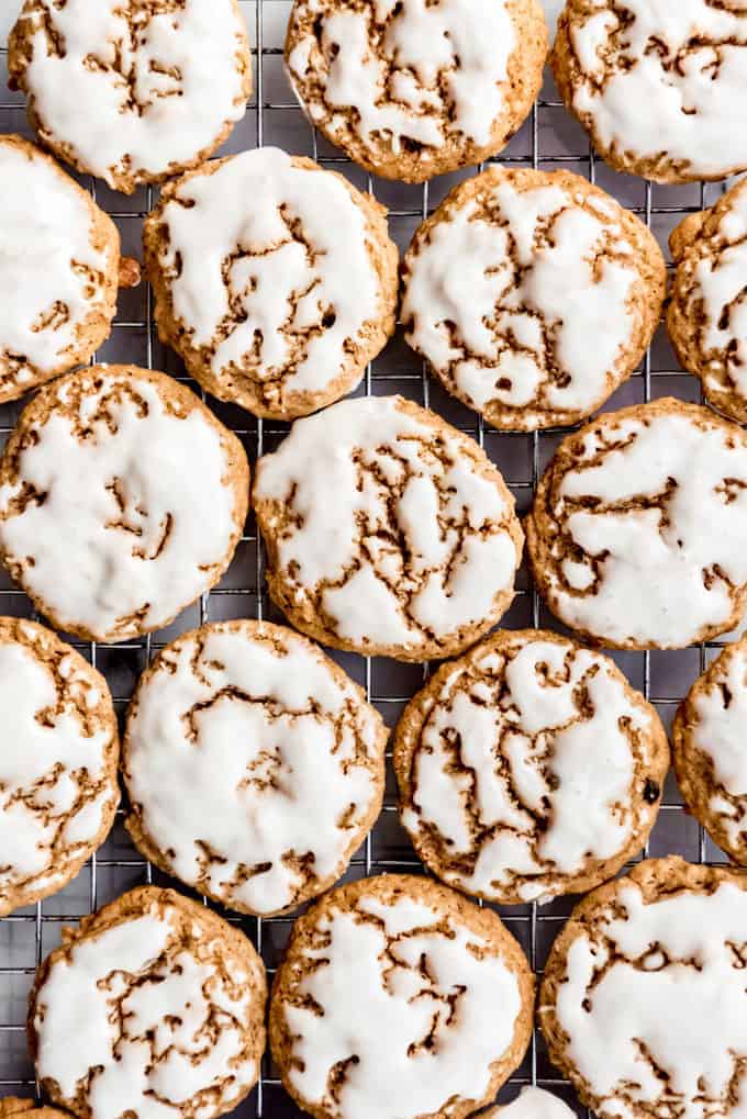 An image of glazed iced oatmeal cookies on a wire cooling rack.