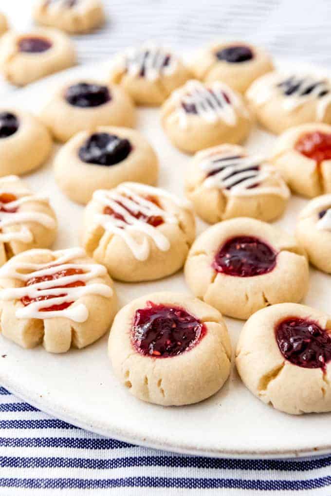 An image of jam thumbprint cookies on a plate.