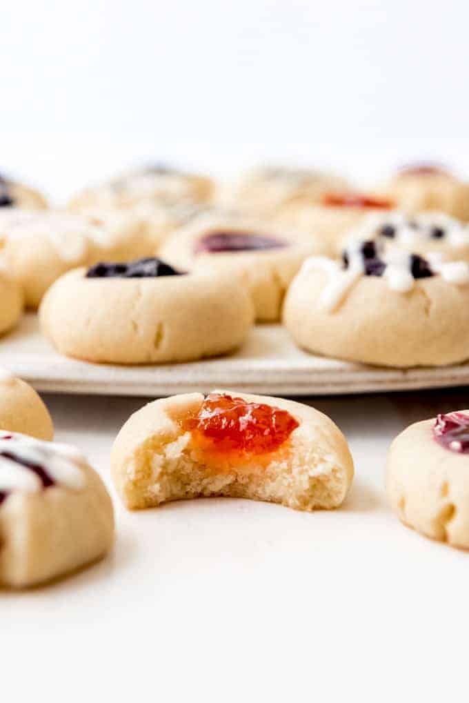 An image of a thumbprint cookie with a bite taken out of it.