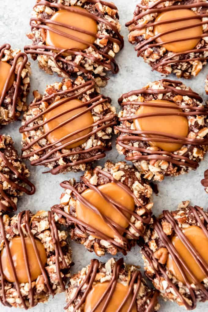 An image of chocolate thumbprint cookies with caramel and pecans.