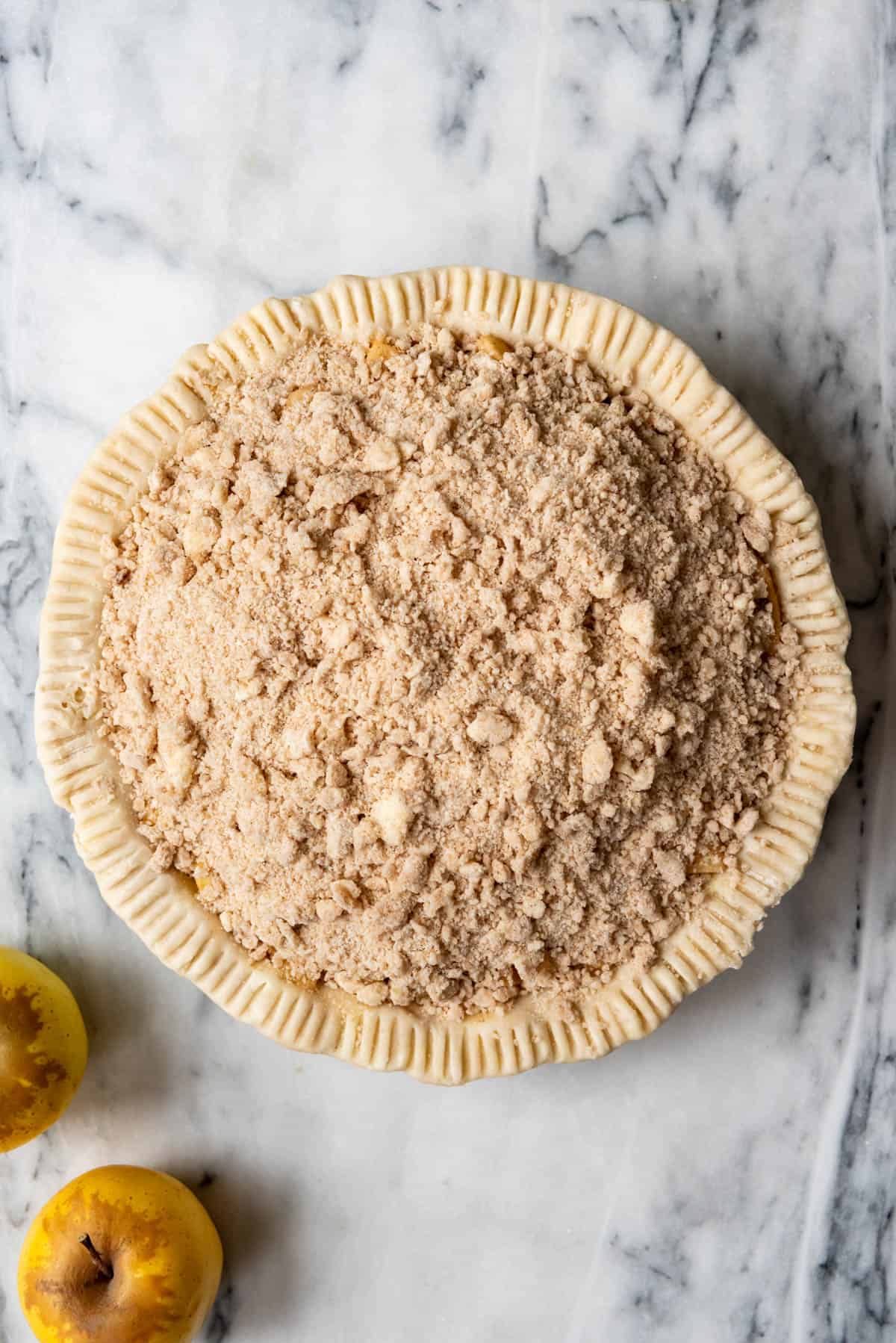 An image of an unbaked dutch apple pie.