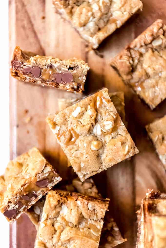 An image of chocolate oatmeal caramel carmelita bars cut into squares.