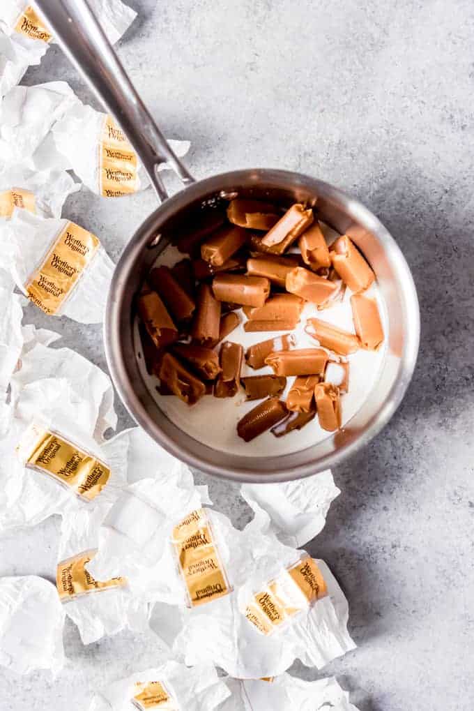 An image of unwrapped Werther's original chewy caramels in a saucepan with cream.