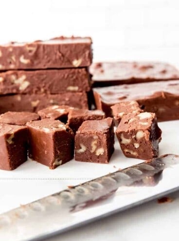 An image of small squares of homemade chocolate walnut fudge.