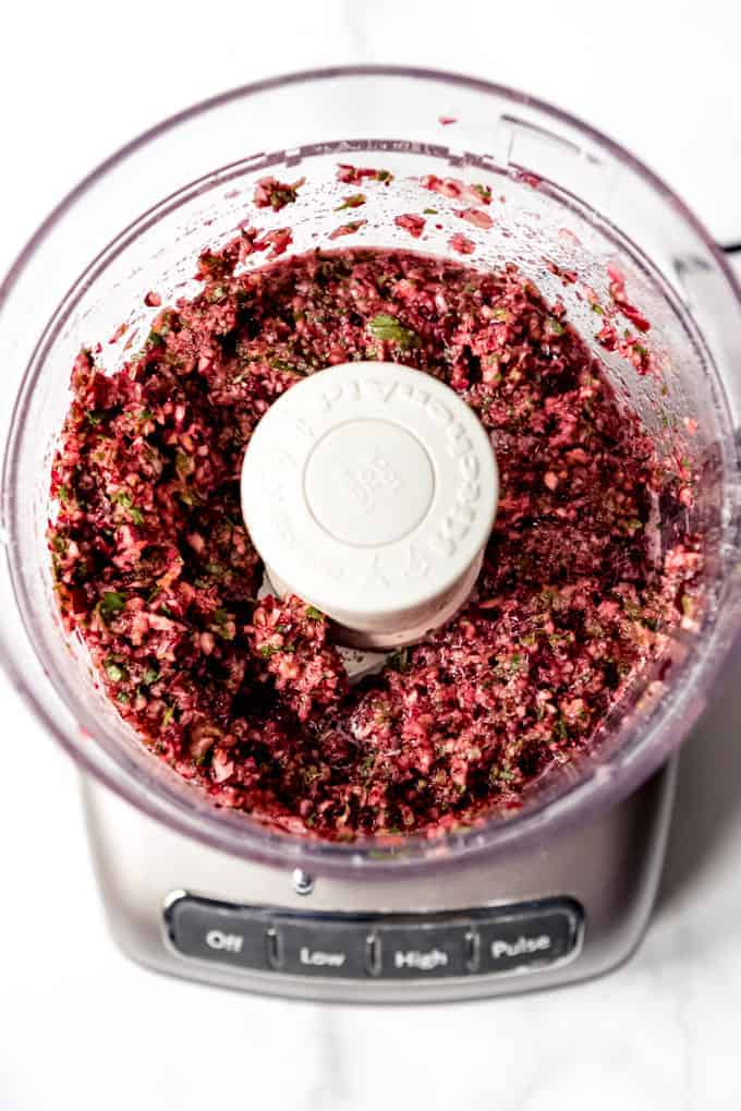 An image of chopped cranberries in a food processor.