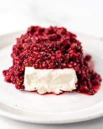 An image of cranberry salsa with cream cheese on a plate.