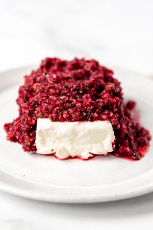 An image of cranberry salsa with cream cheese on a plate.