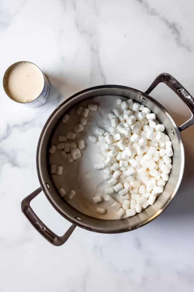 An image of a large pot with sugar, marshmallows, and evaporated milk.