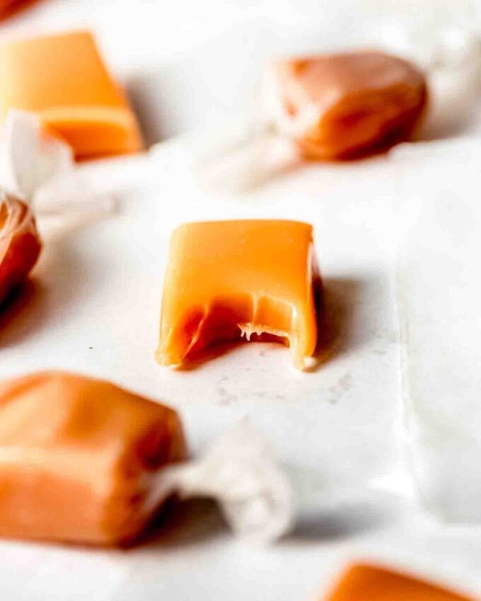 An image of a soft cream caramel with a bite taken out of it.