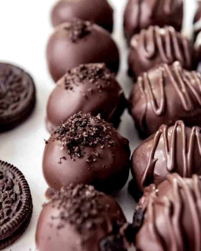 An image of chocolate-covered Oreo balls topped with crushed Oreo crumbs for decoration.