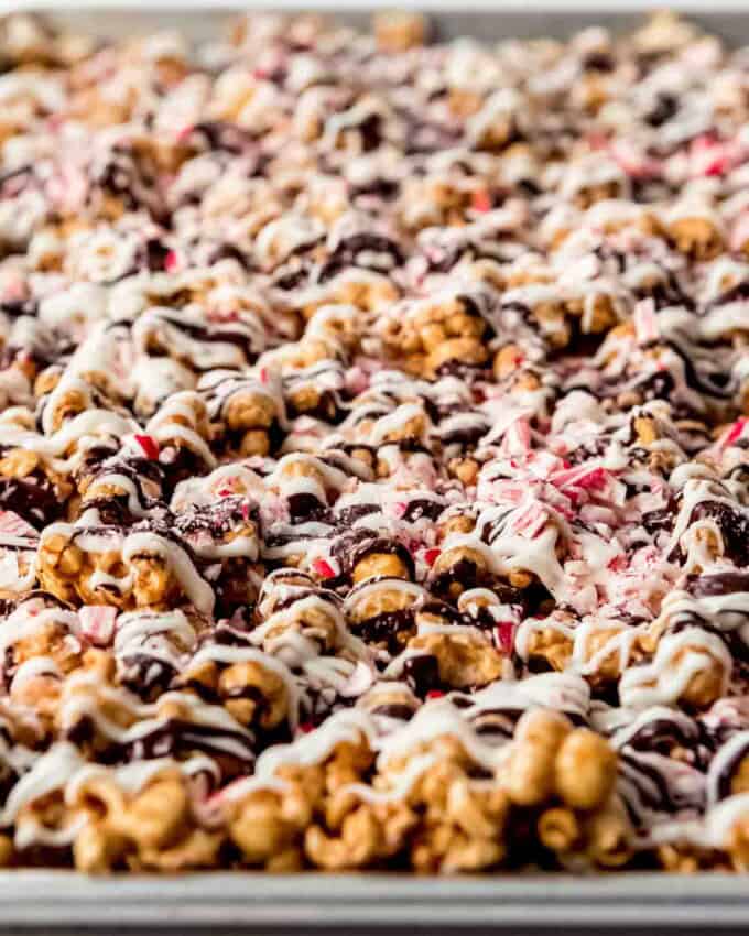 An image of peppermint bark caramel corn on a baking sheet.