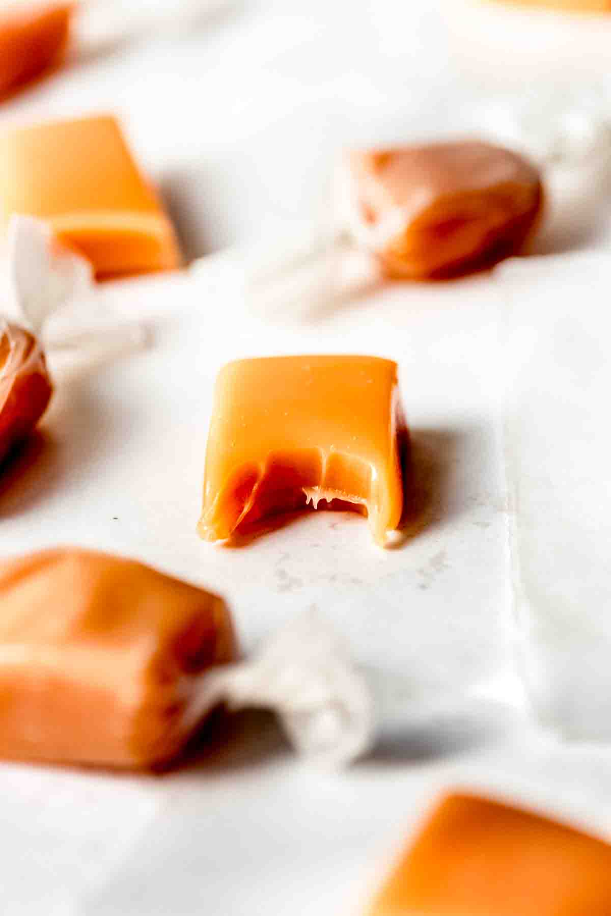 An image of a soft cream caramel with a bite taken out of it.