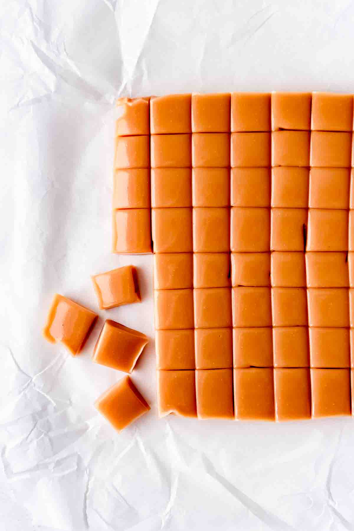 An image of a sheet of caramel that has been cut into small squares.