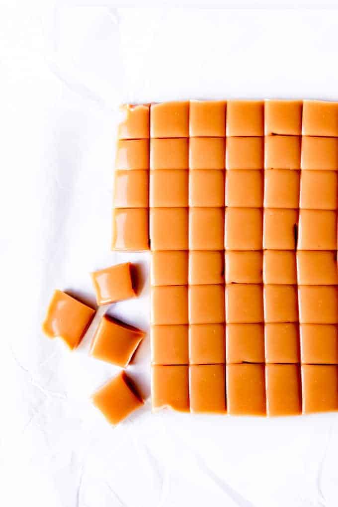 An image of a sheet of caramel that has been cut into small squares.