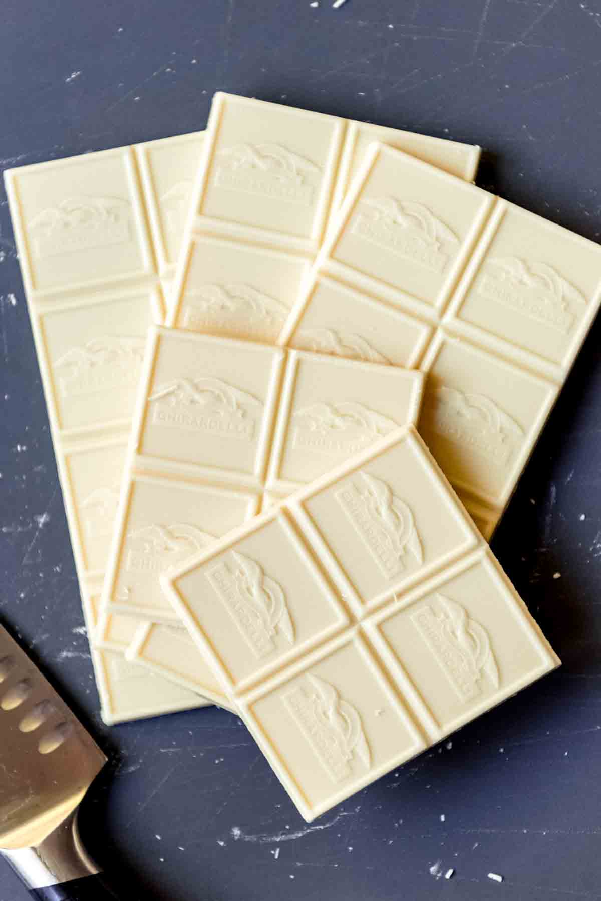 White chocolate squares on a cutting board.