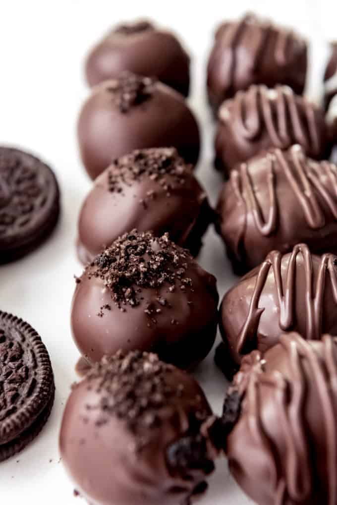 An image of chocolate-covered Oreo balls topped with crushed Oreo crumbs for decoration.