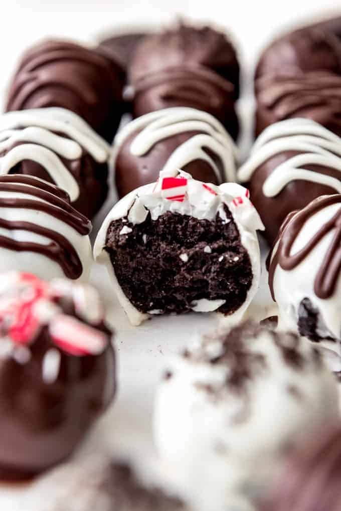 An image of a peppermint Oreo ball truffle with a bite taken out of it.
