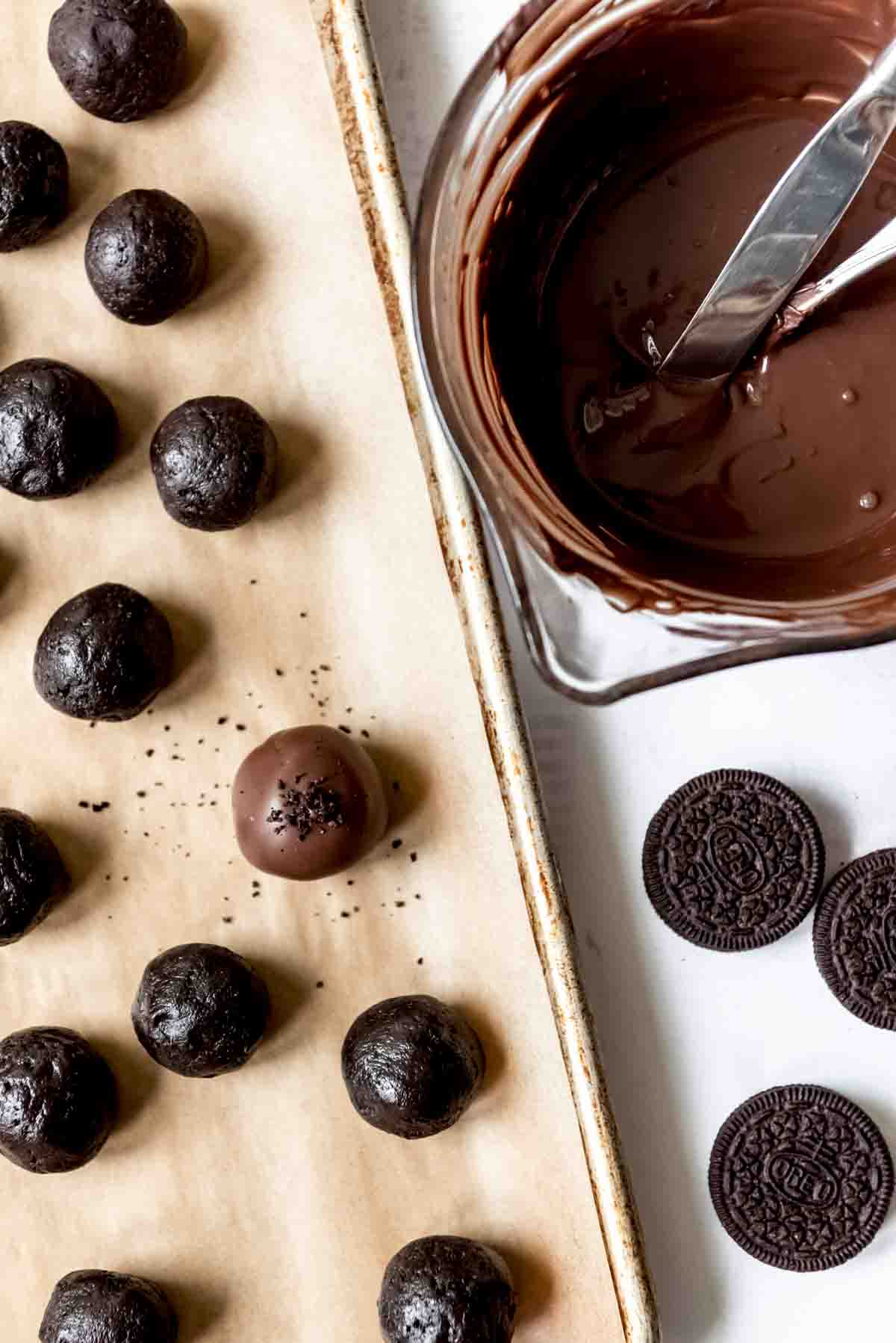 An image of an Oreo ball dipped in chocolate and sprinkled with crushed Oreos.