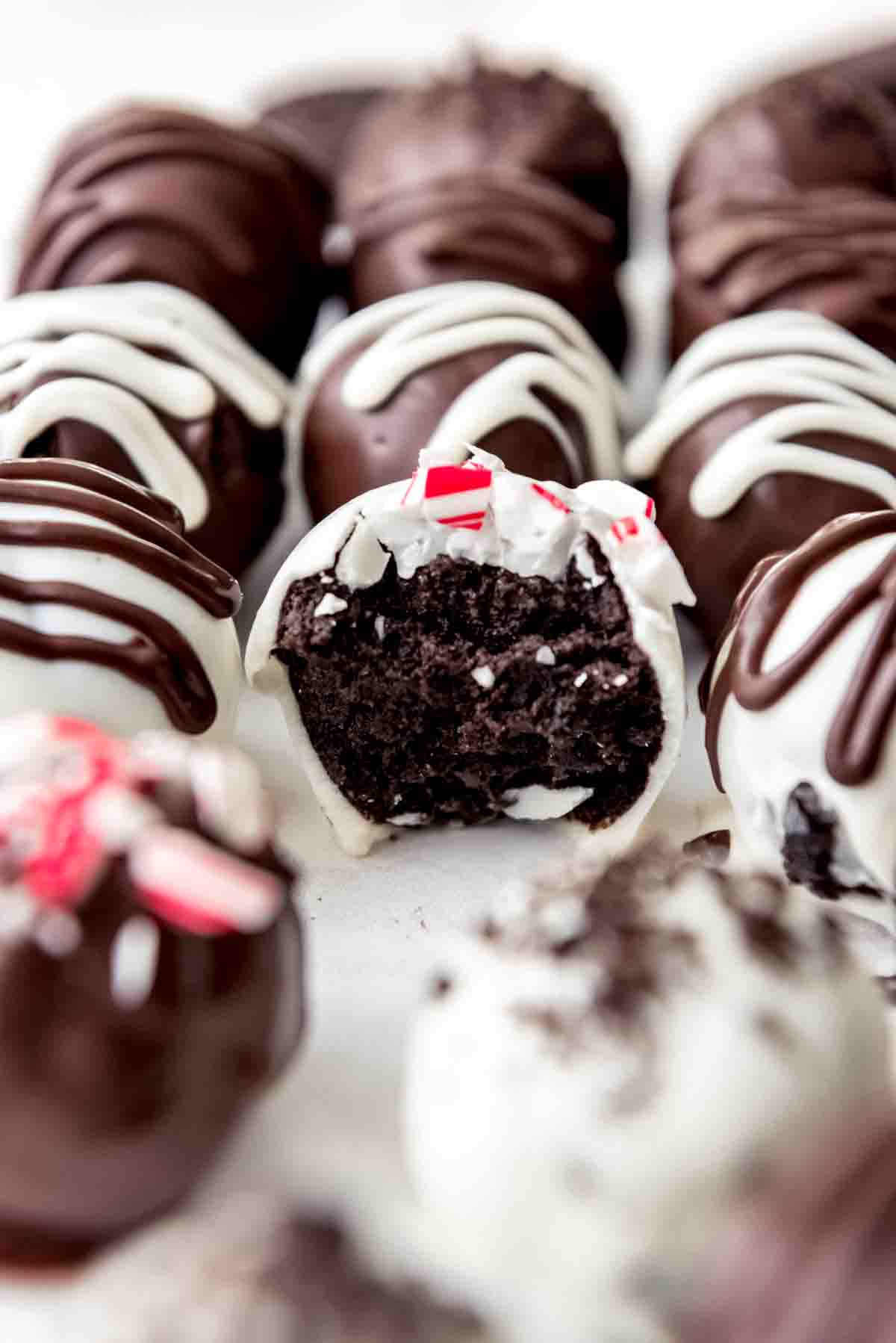 An image of a peppermint Oreo ball truffle with a bite taken out of it.