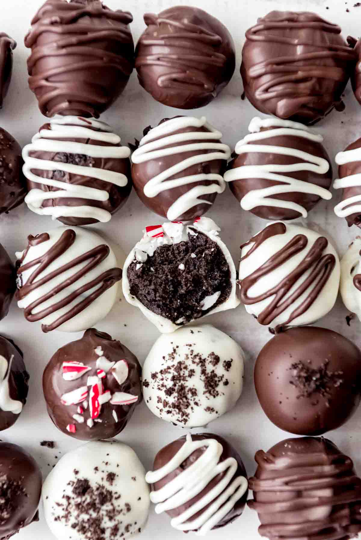 An image of Oreo truffles with one bite taken out of one of them.