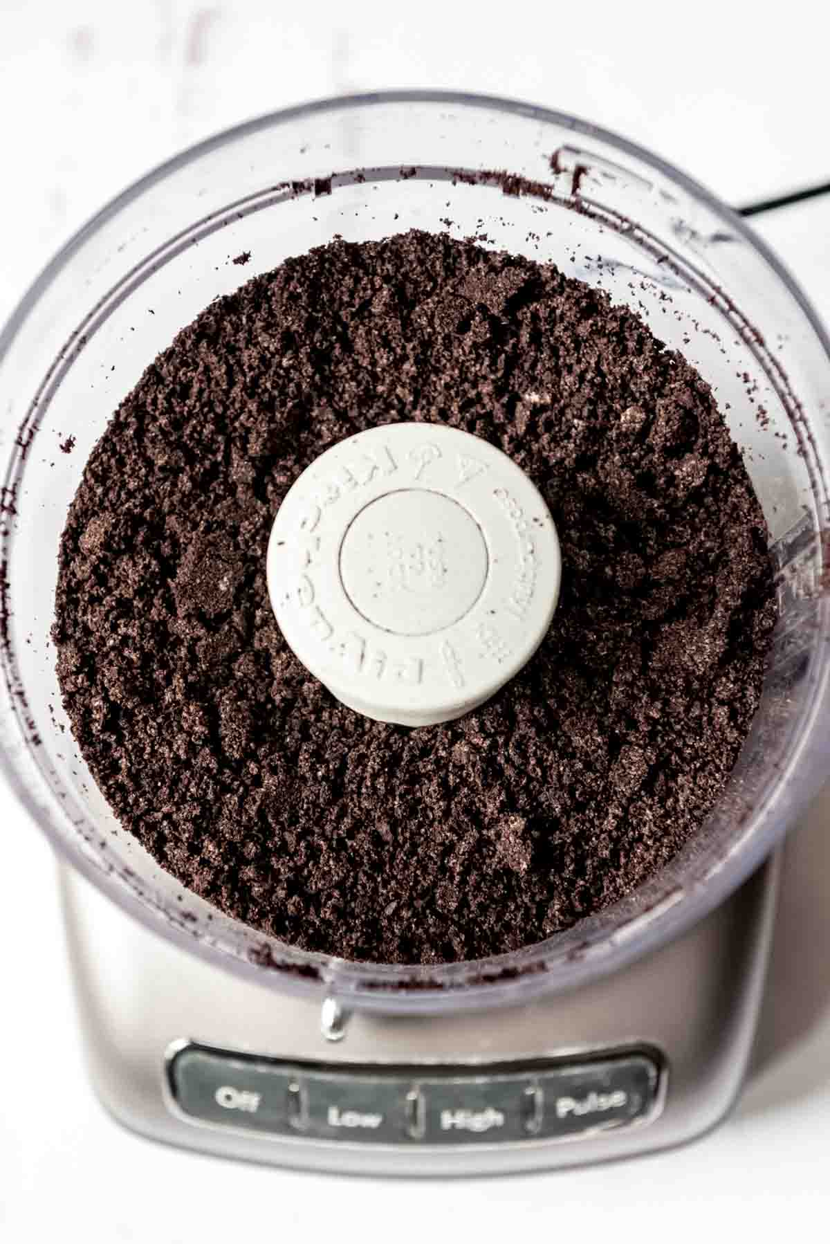 Oreo cookie crumbs in a food processor.