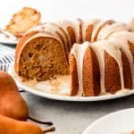 A pear ginger bundt cake on a white plate.