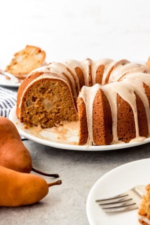 A pear ginger bundt cake on a white plate.