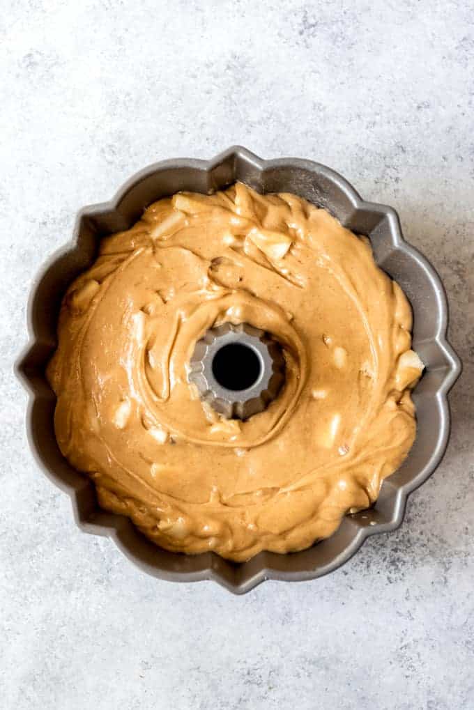 An image of spice cake butter with pears mixed in in a bundt cake pan.
