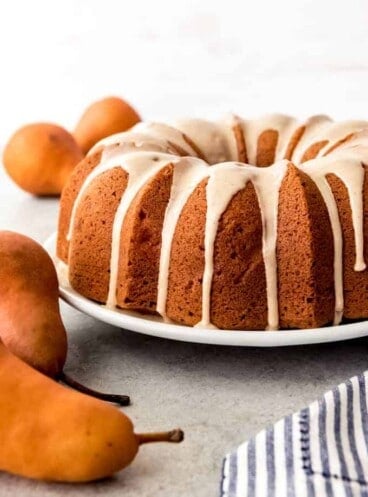An image of a pear ginger bundt cake with a pear glaze dripping down the sides.