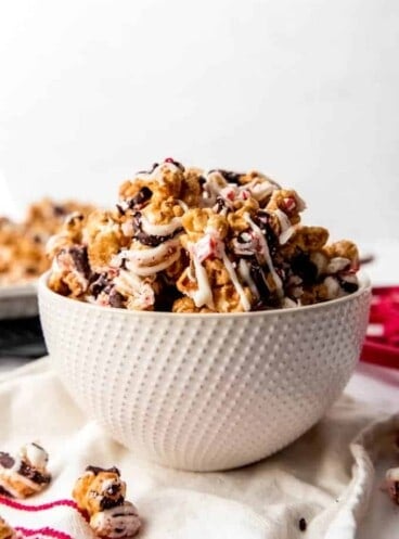 An image of a bowl filled with gourmet homemade popcorn drizzled in white and dark chocolate.