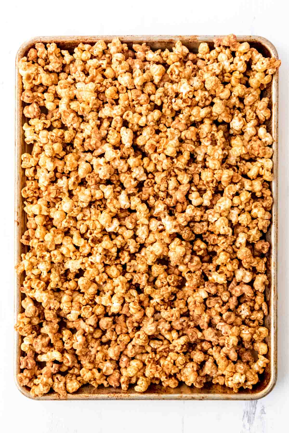 An image of caramel corn on a baking sheet.