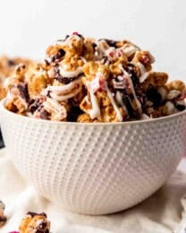 An image of a bowl filled with gourmet homemade popcorn drizzled in white and dark chocolate.