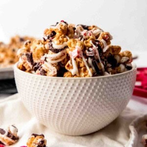 An image of a bowl filled with gourmet homemade popcorn drizzled in white and dark chocolate.