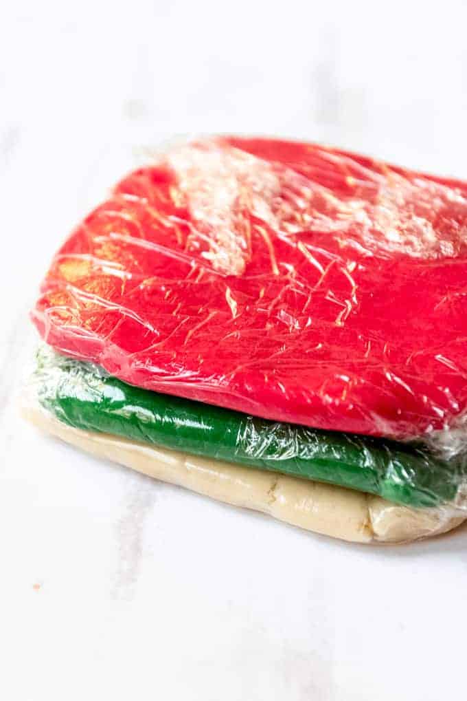 An image of sugar cookie dough dyed red, green, and white.