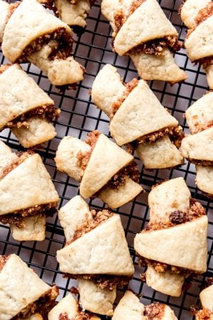 An image of cinnamon walnut rugelach on a wire cooling rack.